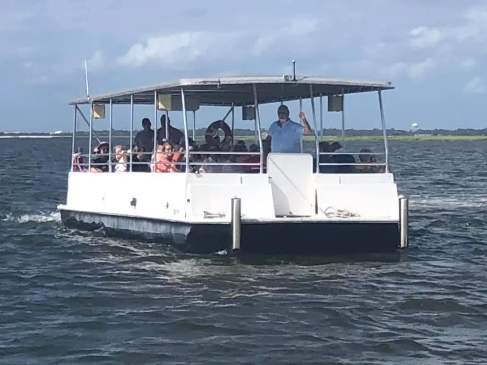 Our covered tour boat cruising with guests aboard