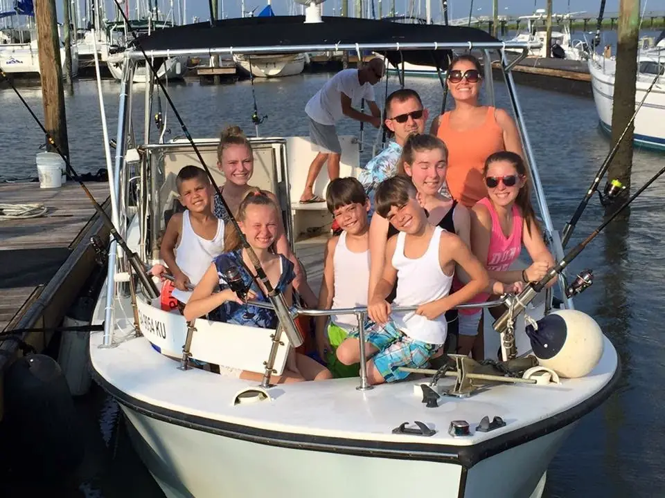A family aboard a fishing boat at the marina