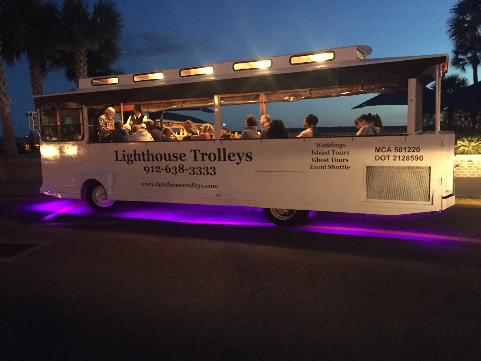 A Lighthouse Trolleys trolley lit up at night before a ghost tour