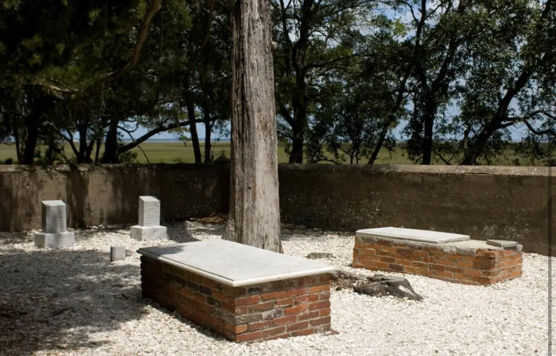 Old tombs in a small island graveyard shaded by trees