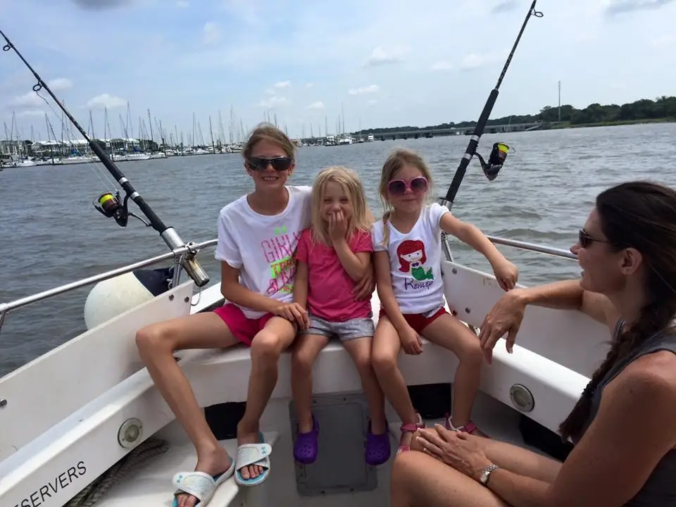 Kids fishing from the boat on calm inshore water
