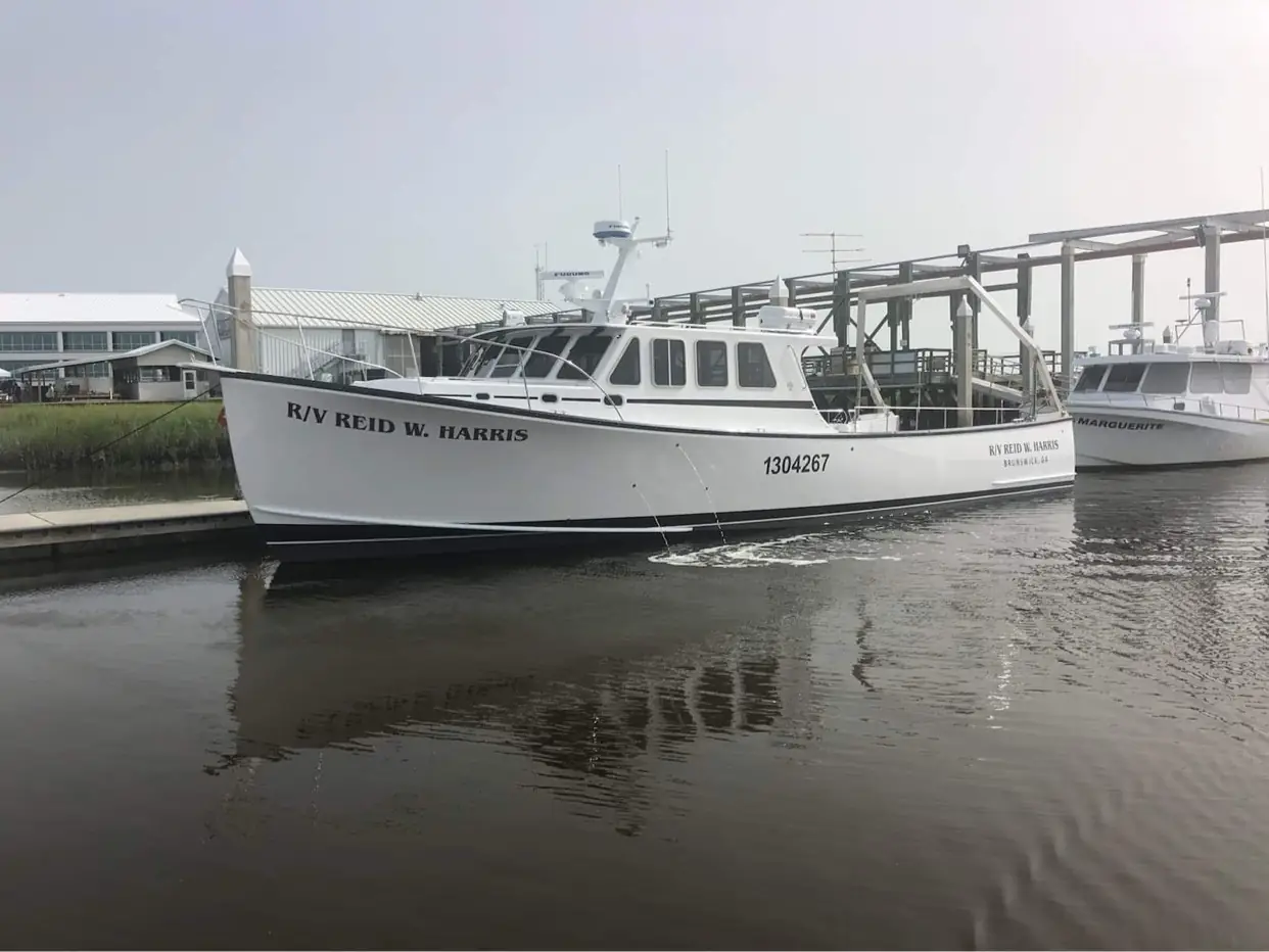 The R/V Reid W. Harris on the water near the dock