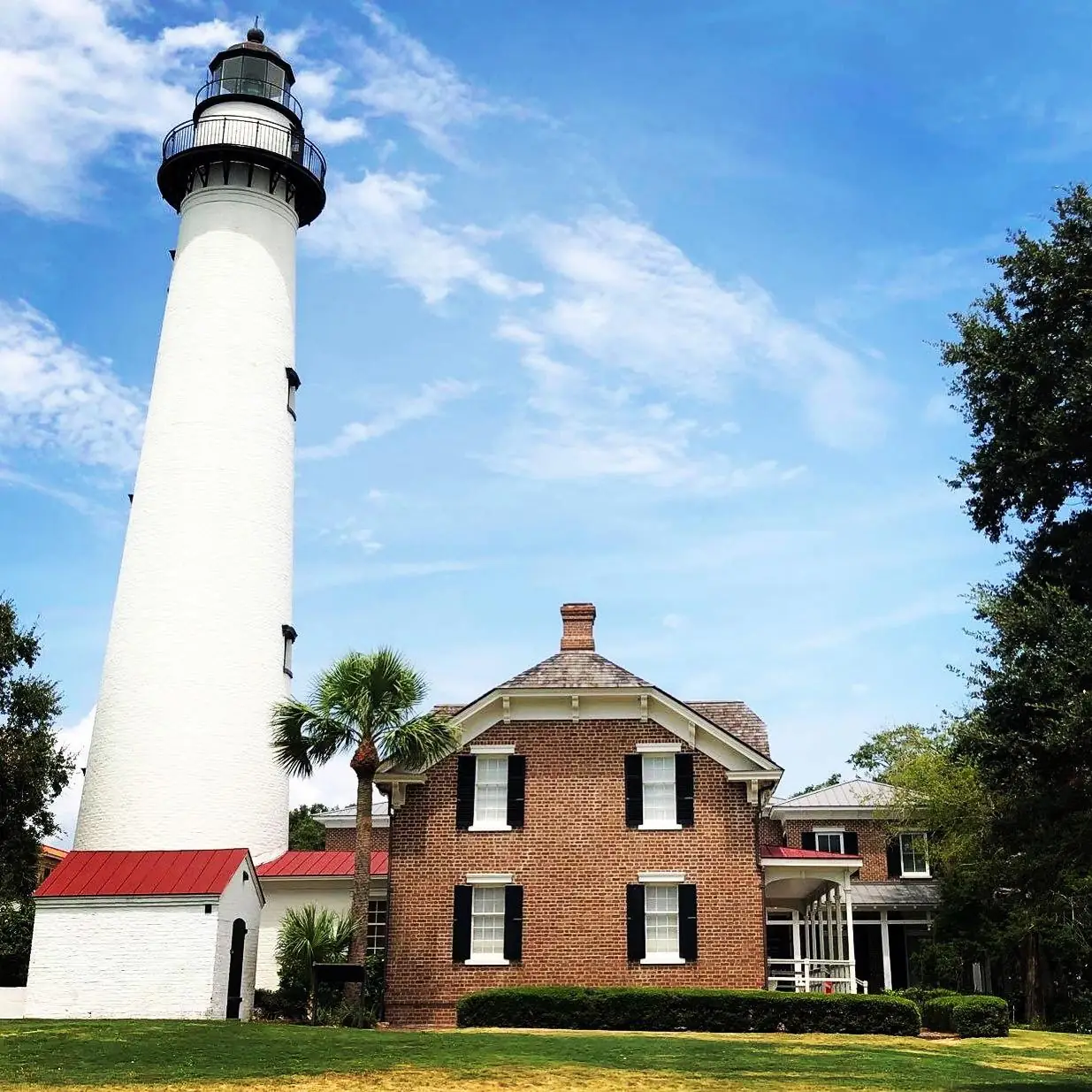 The St. Simons Island Lighthouse and keeper's house on a sunny day