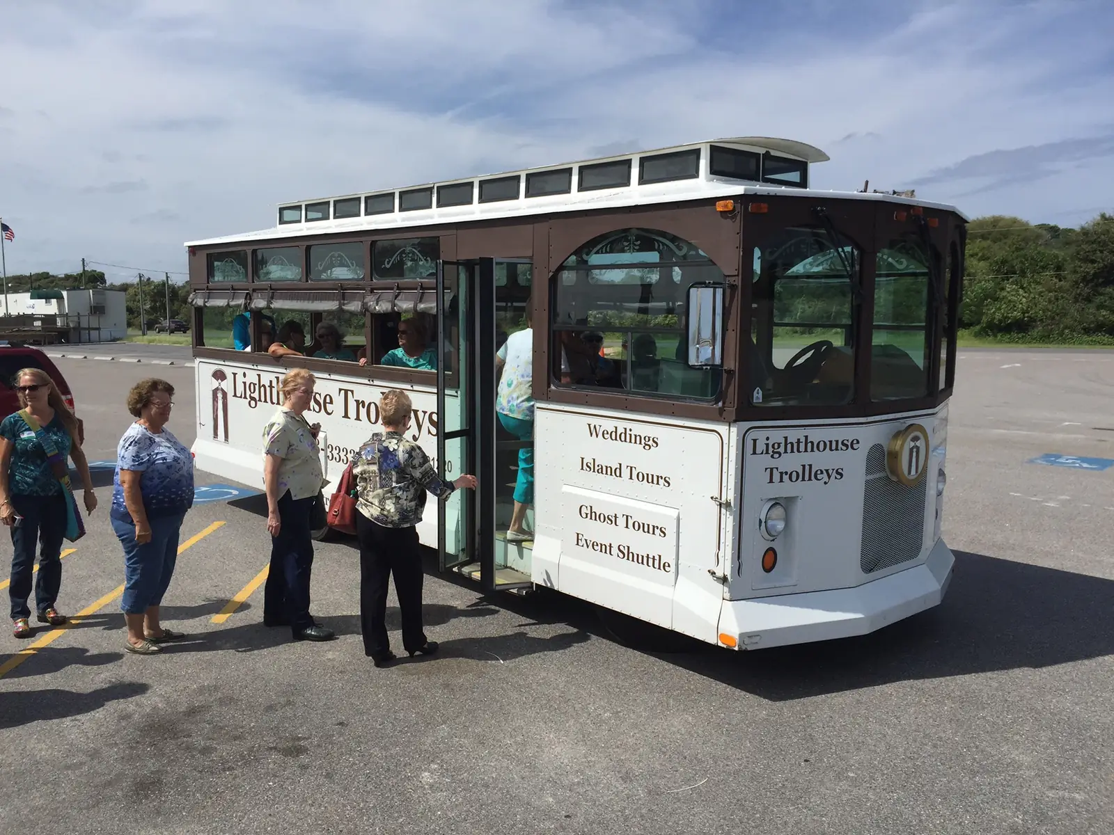 Guests boarding a white Lighthouse Trolleys trolley