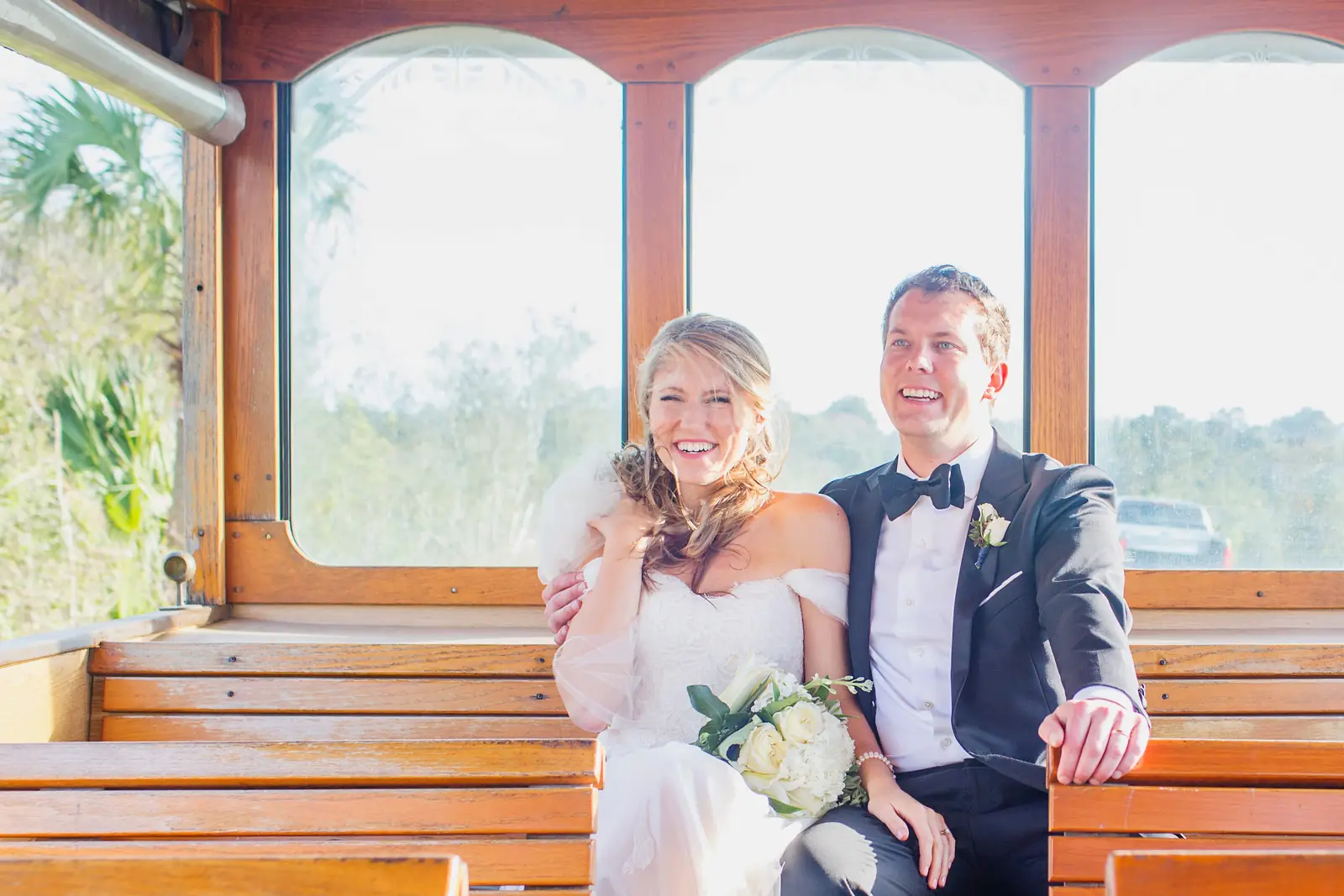Newlyweds seated inside a classic trolley